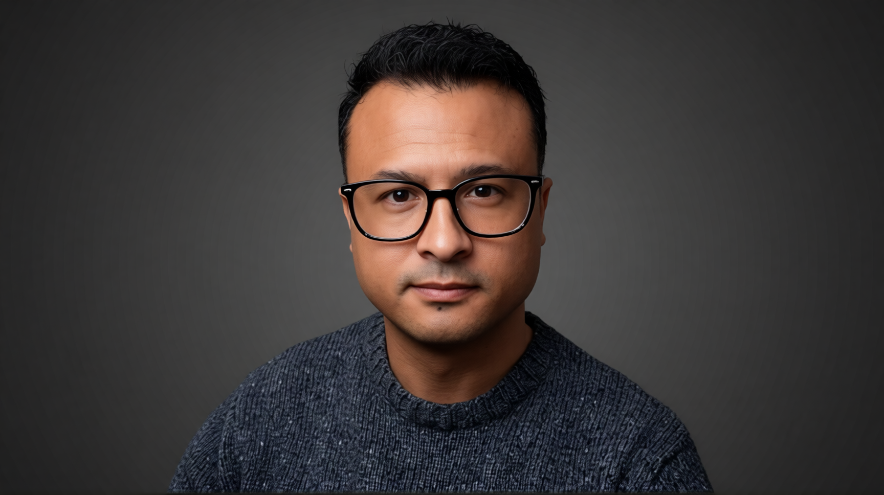 Portrait of Jonathan V. Rydberg against a charcoal background